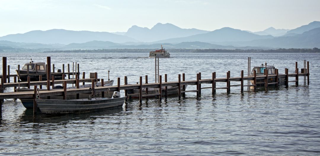 Peaceful Lake Scene with Dock and Mountains in Background - Free Images, Stock Photos and Pictures on Pikwizard.com