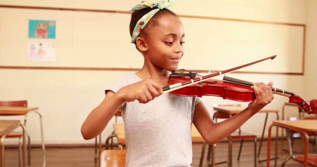 Young Student Playing Violin in Classroom