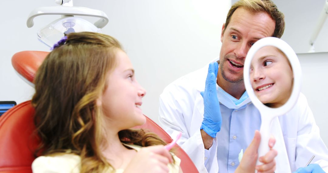 Dentist Interacting with Child at Dental Check-Up - Free Images, Stock Photos and Pictures on Pikwizard.com