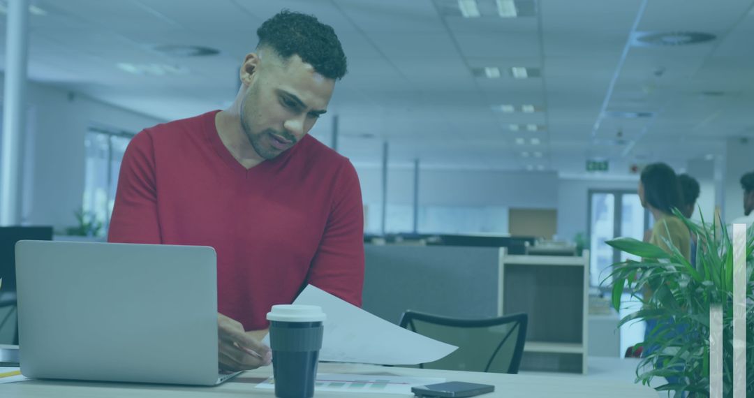 Professional Man Reviewing Documents in Office Setting