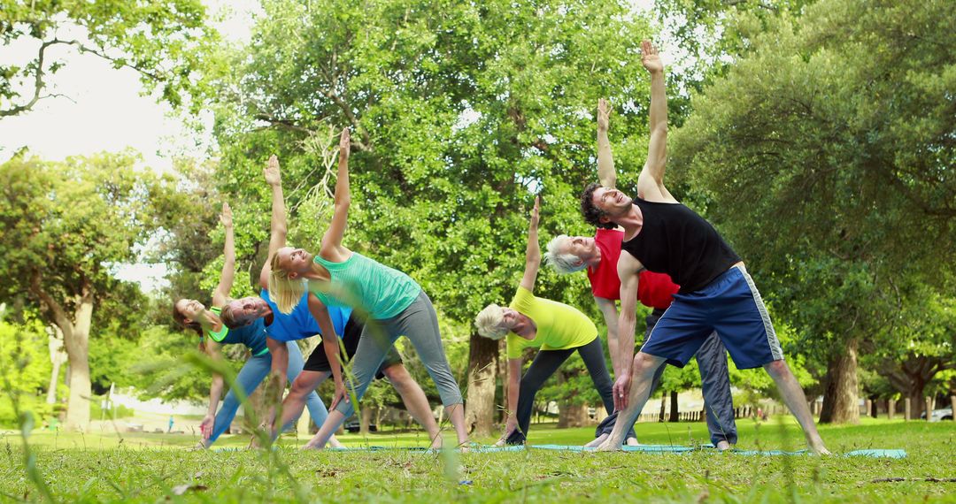 Group Practicing Outdoor Yoga in Vibrant Park Setting - Free Images, Stock Photos and Pictures on Pikwizard.com