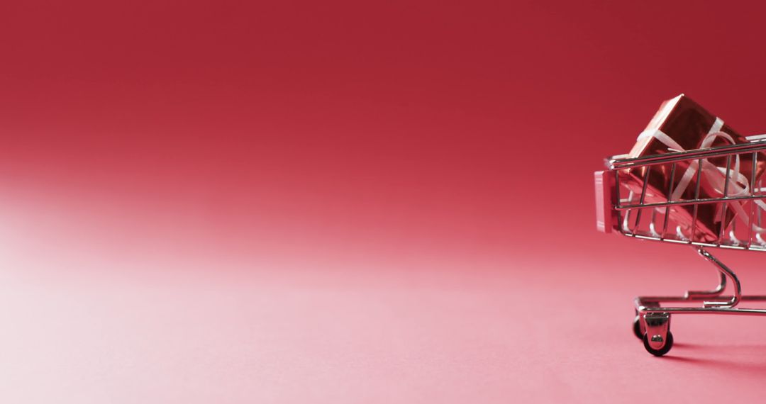 Mini Shopping Cart with Gift on Red Background