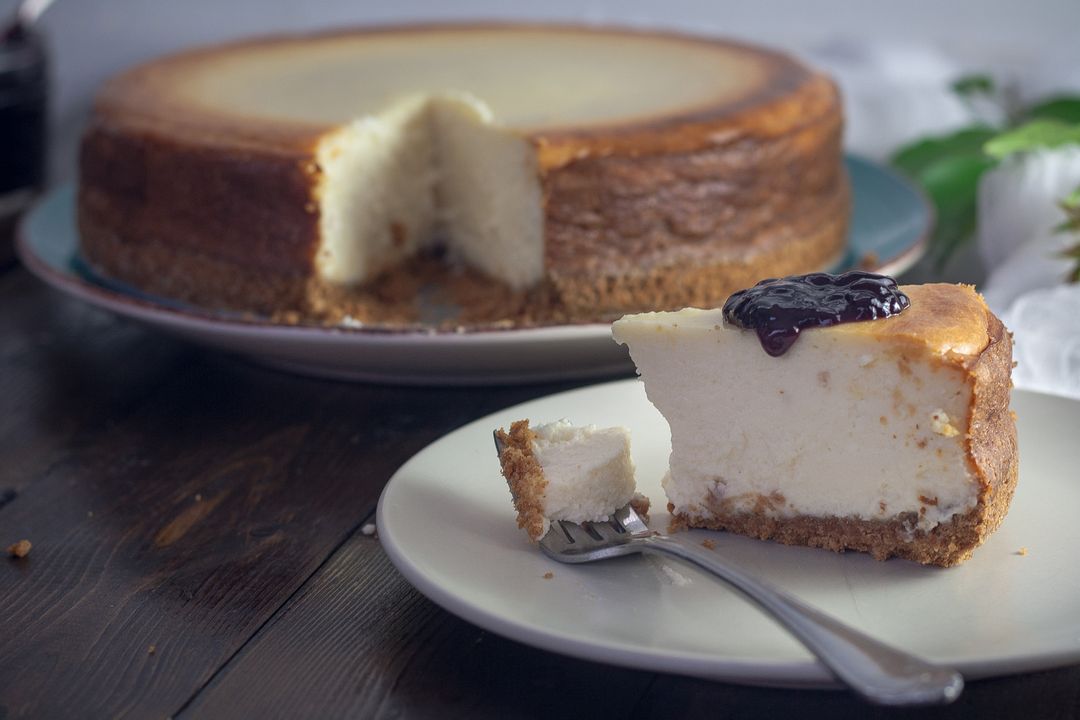 Decadent Vanilla Cheesecake with Berry Garnish on Rustic Background