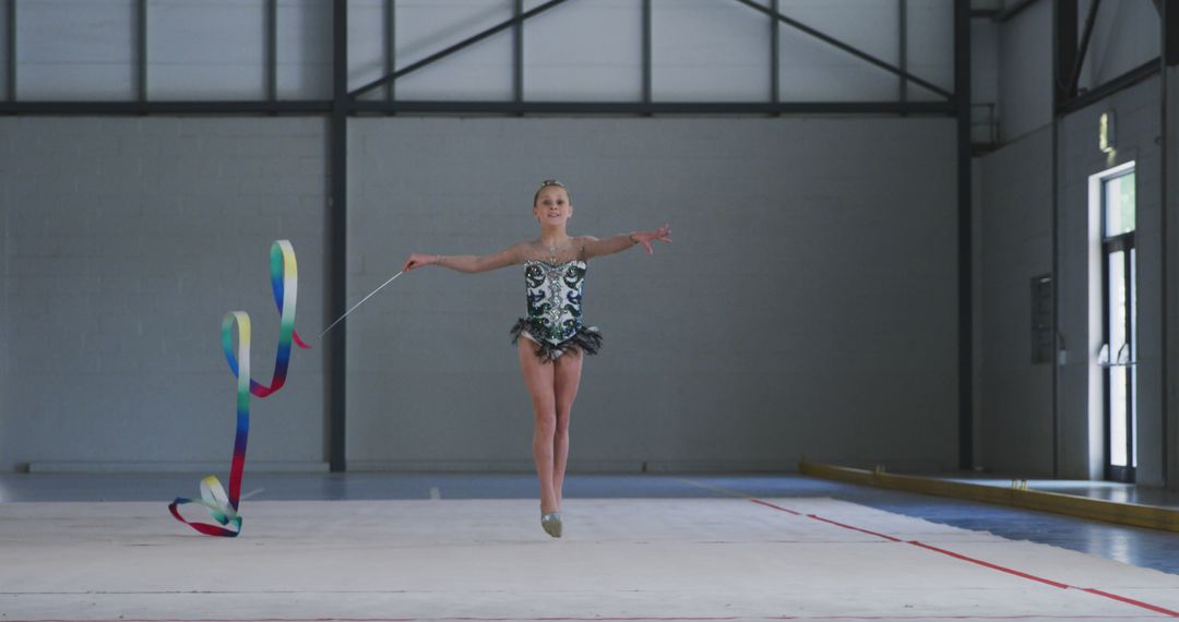Young Gymnast Practicing Ribbon Routine in Sports Hall