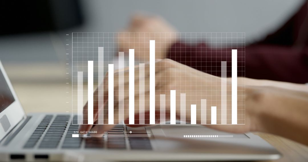 Hands Typing on Laptop with Overlay of Digital Bar Graph
