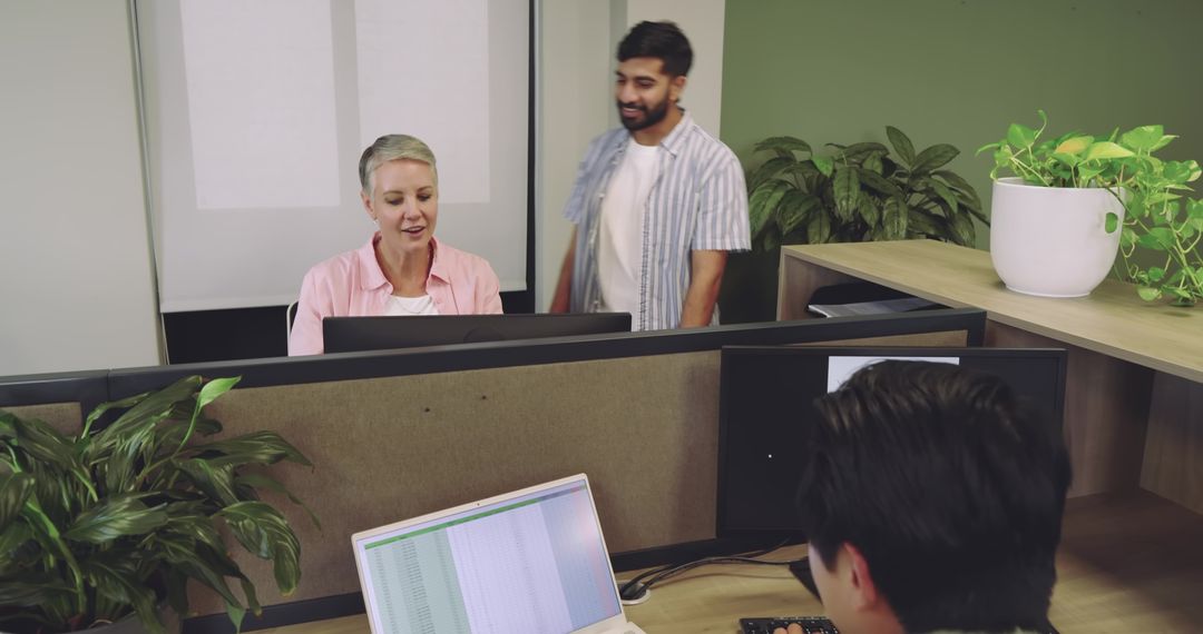 Diverse Coworkers Collaborate in Eco-Friendly Office Setting