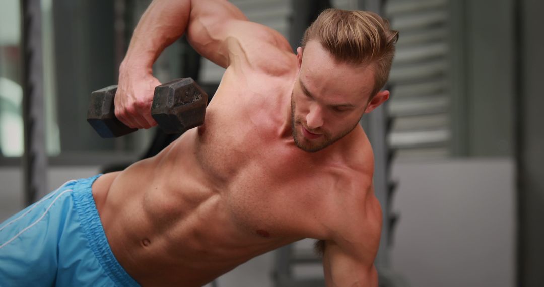 Fit Man Performing Dumbbell Rows in Gym - Free Images, Stock Photos and Pictures on Pikwizard.com