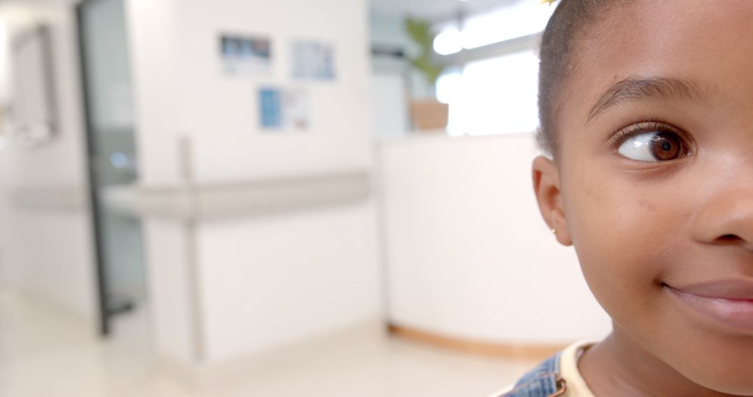 Close-Up of Smiling Child in Bright Hospital Corridor - Free Images, Stock Photos and Pictures on Pikwizard.com