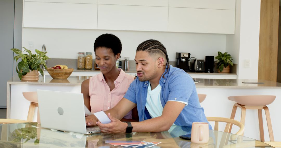 Diverse Couple Collaborating on Financial Planning in Modern Kitchen