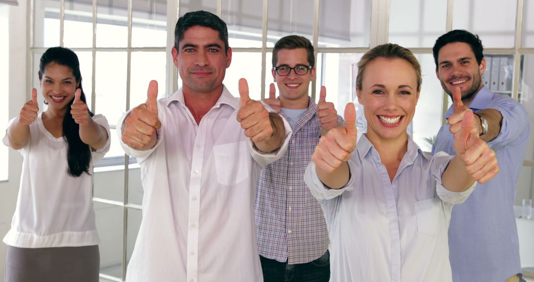 Team of Happy Business People Giving Thumbs Up in Office - Free Images, Stock Photos and Pictures on Pikwizard.com