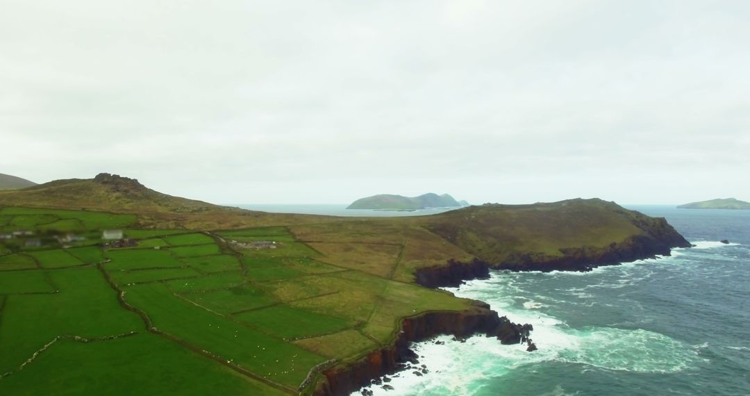 Aerial View of Coastal Irish Countryside with Rugged Cliffs and Farmland - Free Images, Stock Photos and Pictures on Pikwizard.com