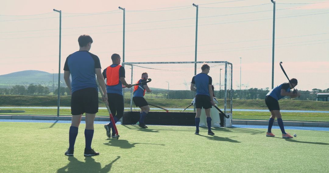 Male Field Hockey Players Practicing on Pitch
