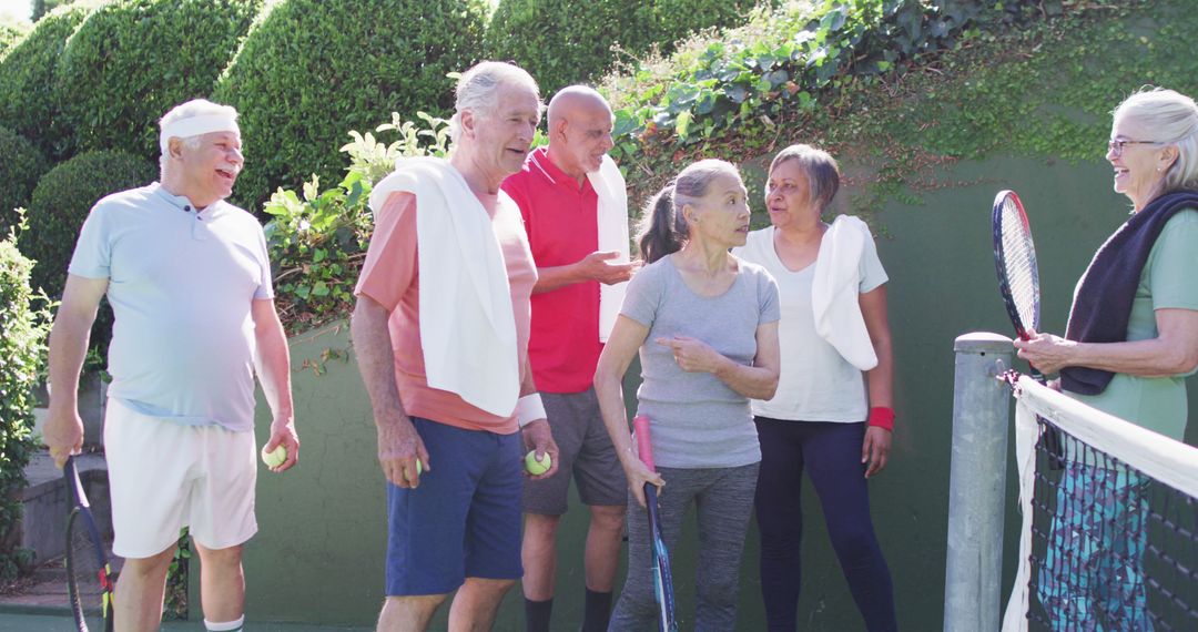 Active Seniors Playing Tennis Outdoors Socializing - Free Images, Stock Photos and Pictures on Pikwizard.com