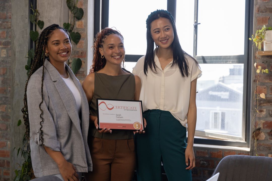 Diverse Team Celebrating Achievement with Award in Modern Office