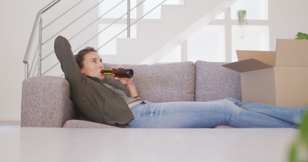 Young Woman Relaxing on Couch After Moving - Free Images, Stock Photos and Pictures on Pikwizard.com