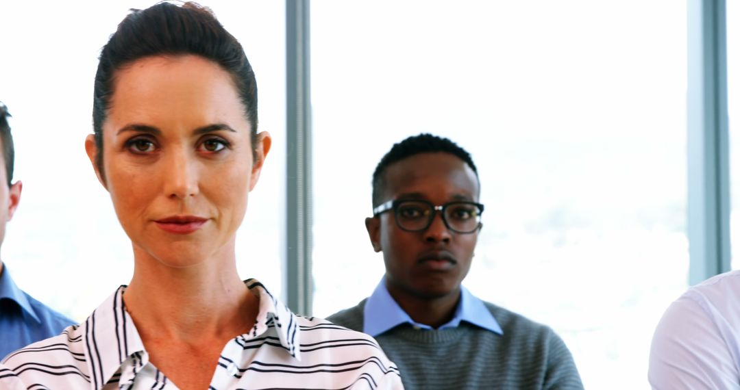 Diverse Professionals Standing in Modern Office Setting