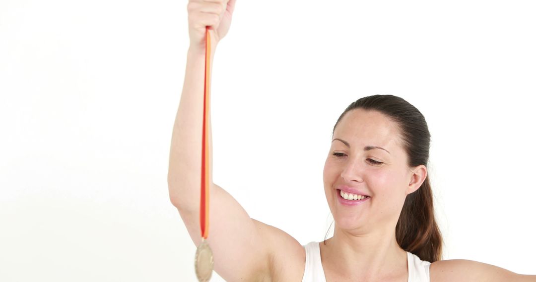 Woman Smiling Holding Medal Celebrating Achievement - Free Images, Stock Photos and Pictures on Pikwizard.com