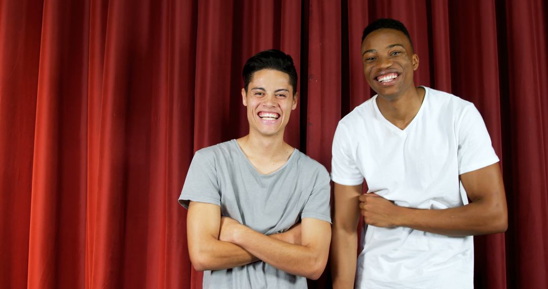 Smiling Friends Posing Against Red Curtain Background - Free Images, Stock Photos and Pictures on Pikwizard.com