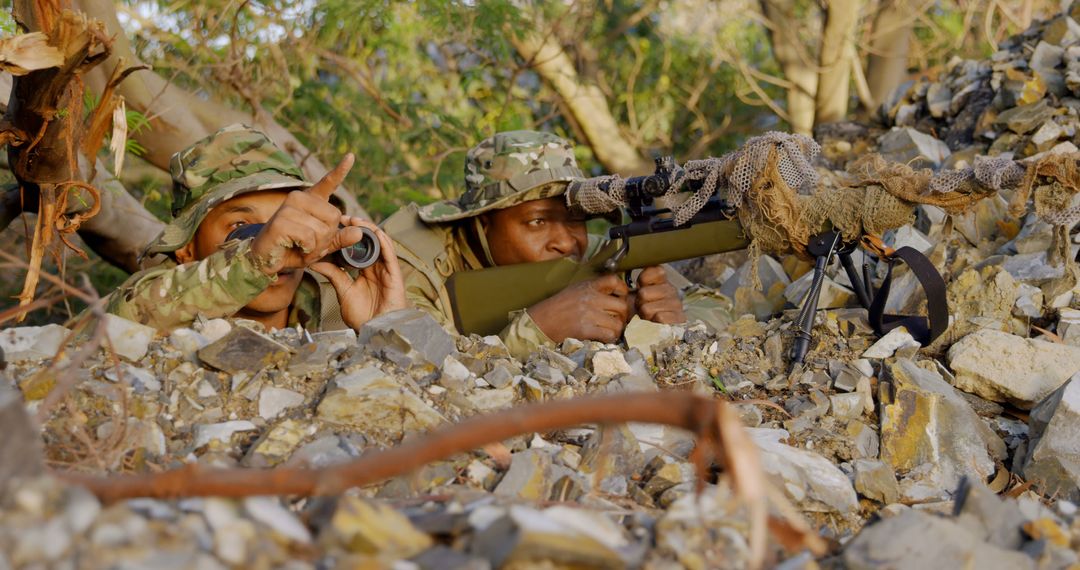 Soldiers in Camouflage Uniforms Hiding and Aiming Rifle in Rocky Terrain - Free Images, Stock Photos and Pictures on Pikwizard.com