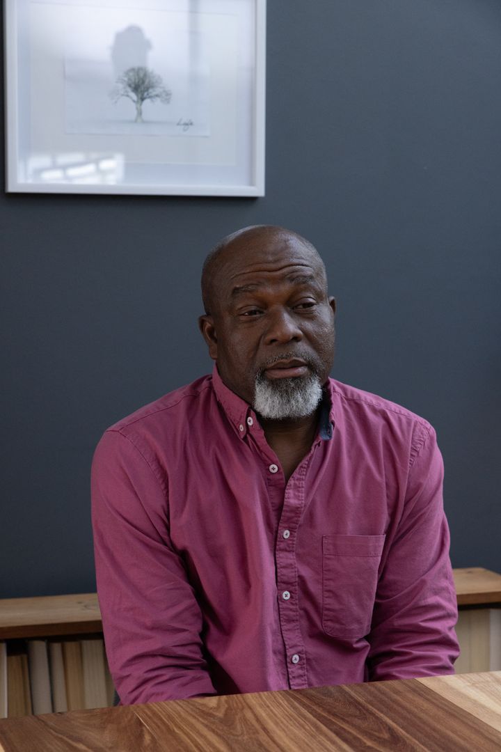 Elderly Man in Reflection at Vintage Studio Table