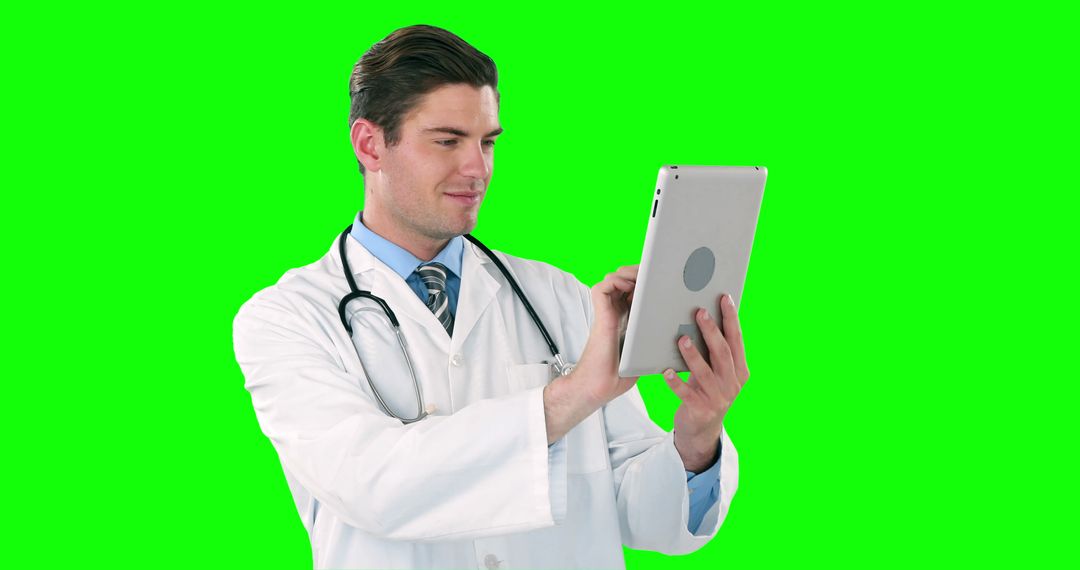 Male Doctor Using Digital Tablet Green Background - Free Images, Stock Photos and Pictures on Pikwizard.com