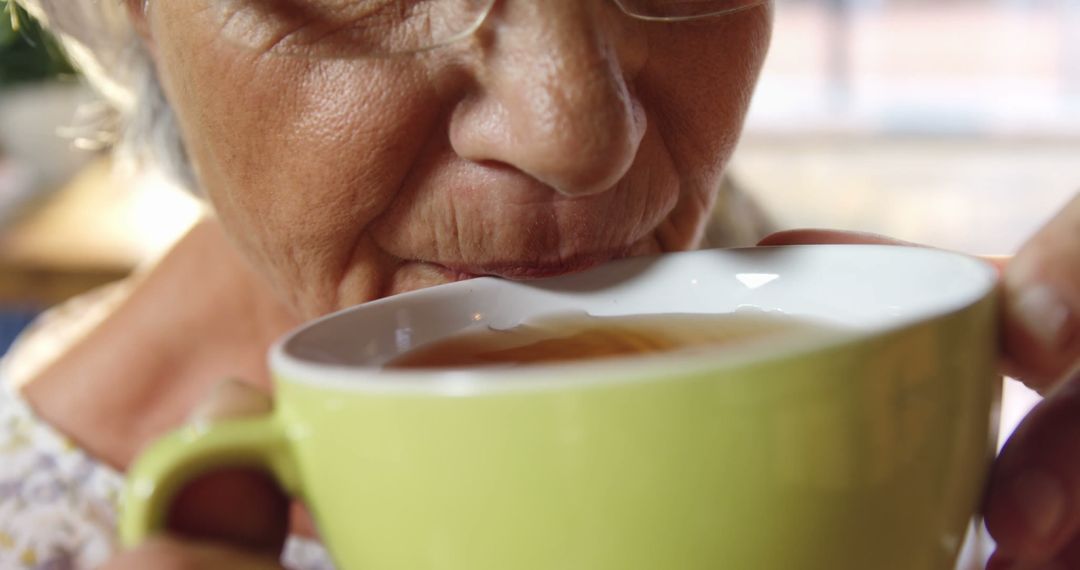 Elderly Woman Drinking Tea from Large Mug Close-Up - Free Images, Stock Photos and Pictures on Pikwizard.com