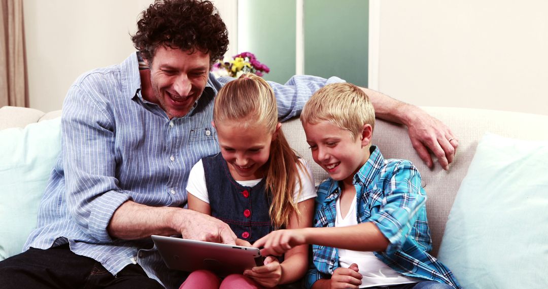 Father with Two Children Using Tablet on Sofa - Free Images, Stock Photos and Pictures on Pikwizard.com