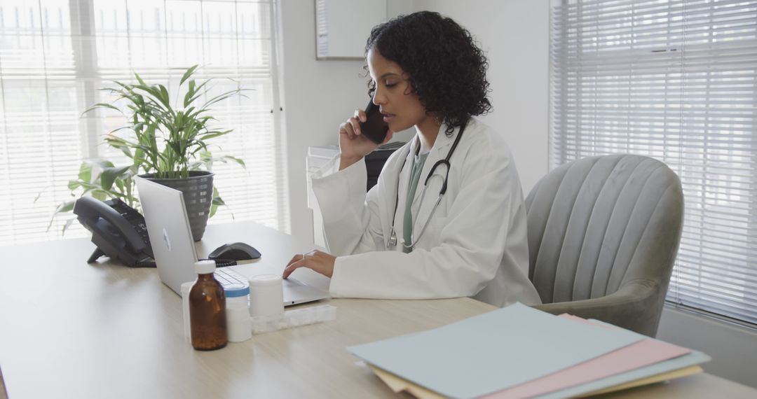 Female Doctor Talking on Phone While Working on Laptop in Office - Free Images, Stock Photos and Pictures on Pikwizard.com