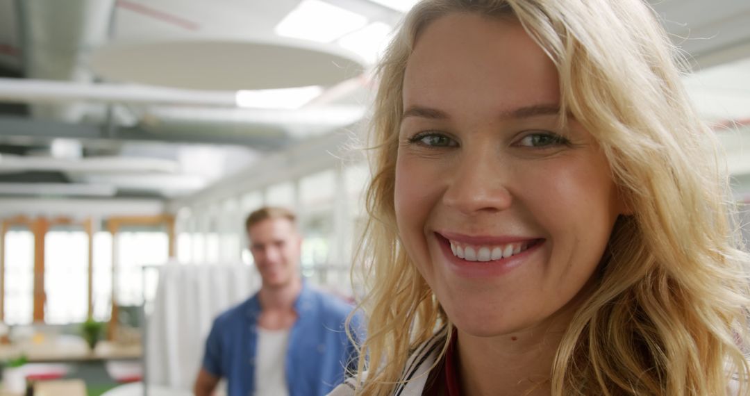 Smiling Caucasian Woman with Colleague in Office Setting