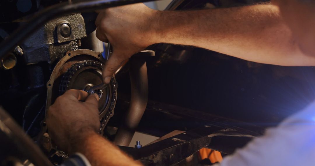 Caucasian Mechanic Fixing Car Engine with Tools
