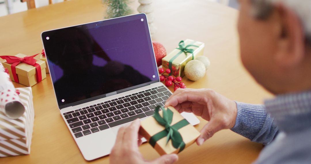 Elderly Man Preparing Christmas Gifts and Video Calling Family - Free Images, Stock Photos and Pictures on Pikwizard.com