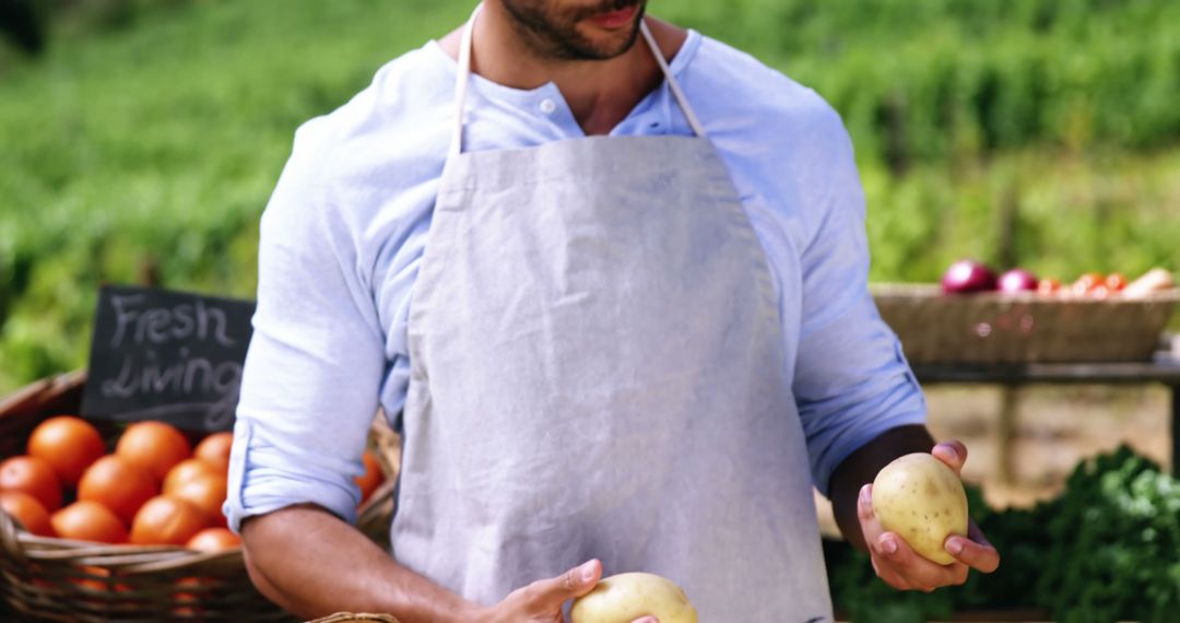 Male Farmer Holding Potatoes at Outdoor Market - Free Images, Stock Photos and Pictures on Pikwizard.com