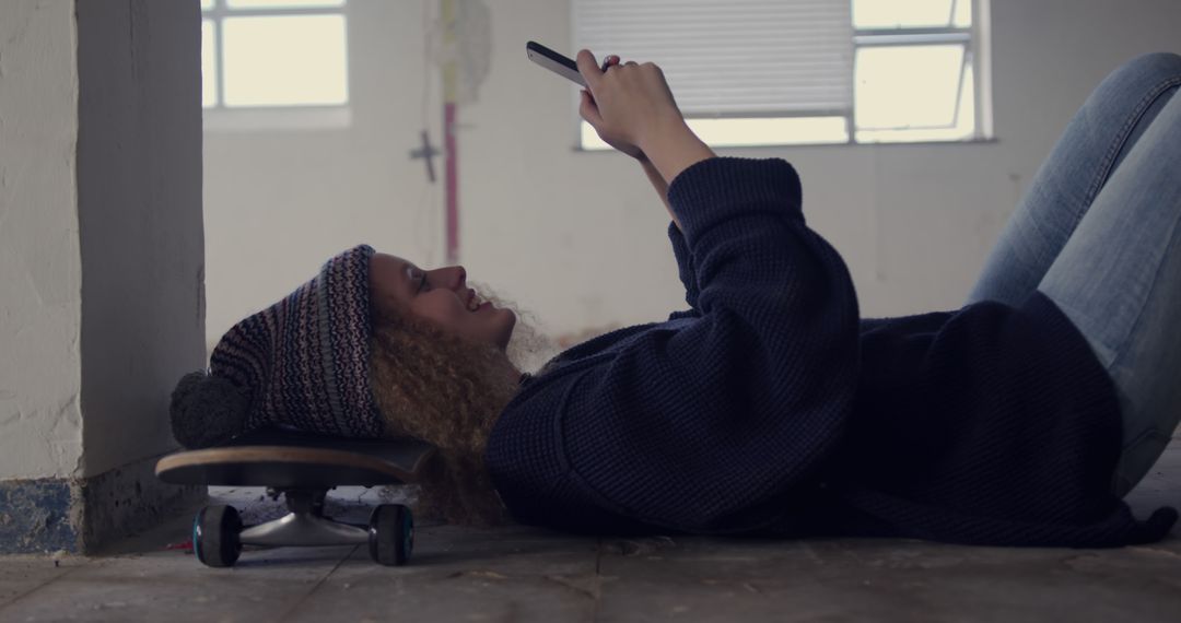 Young Woman Relaxing on Skateboard Using Smartphone - Free Images, Stock Photos and Pictures on Pikwizard.com