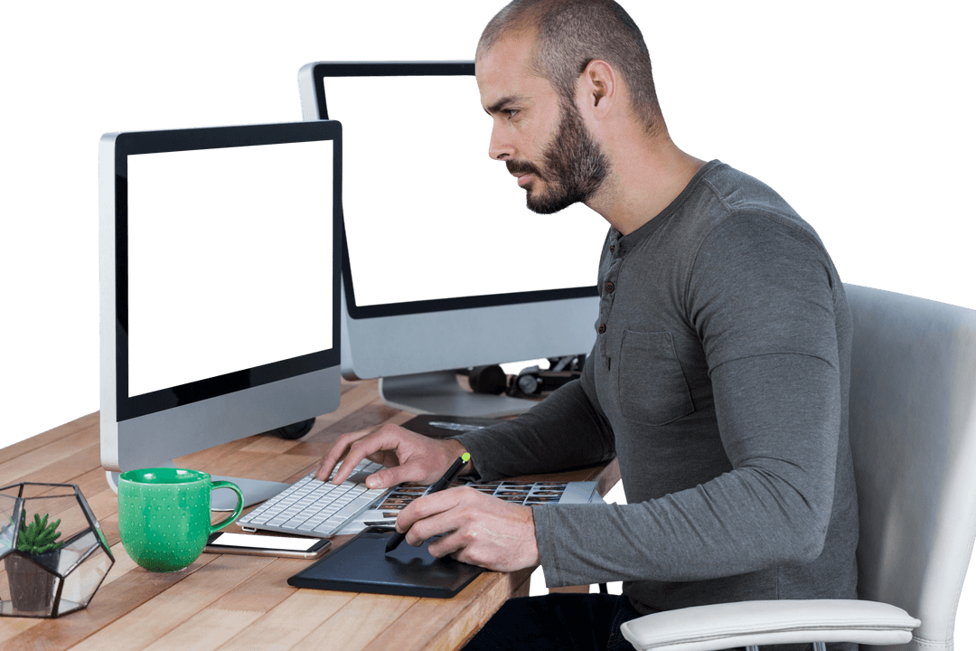 Male Photographer Editing Photos with Graphic Tablet in Transparent Studio Workspace