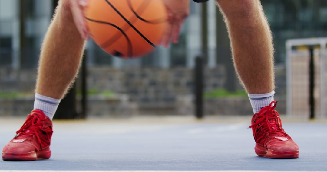 Close-Up of Player Dribbling Basketball in Red Shoes on Outdoor Court - Free Images, Stock Photos and Pictures on Pikwizard.com