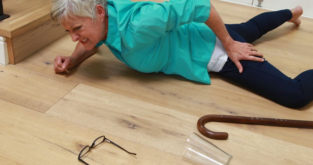 Senior Woman Suffering Fall on Wooden Floor at Home - Free Images, Stock Photos and Pictures on Pikwizard.com