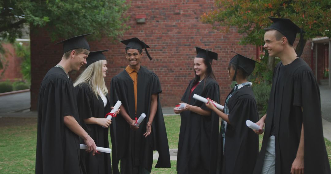 Front view of multi-ethnic group of high school teenage students wearing caps and gowns - Free Images, Stock Photos and Pictures on Pikwizard.com