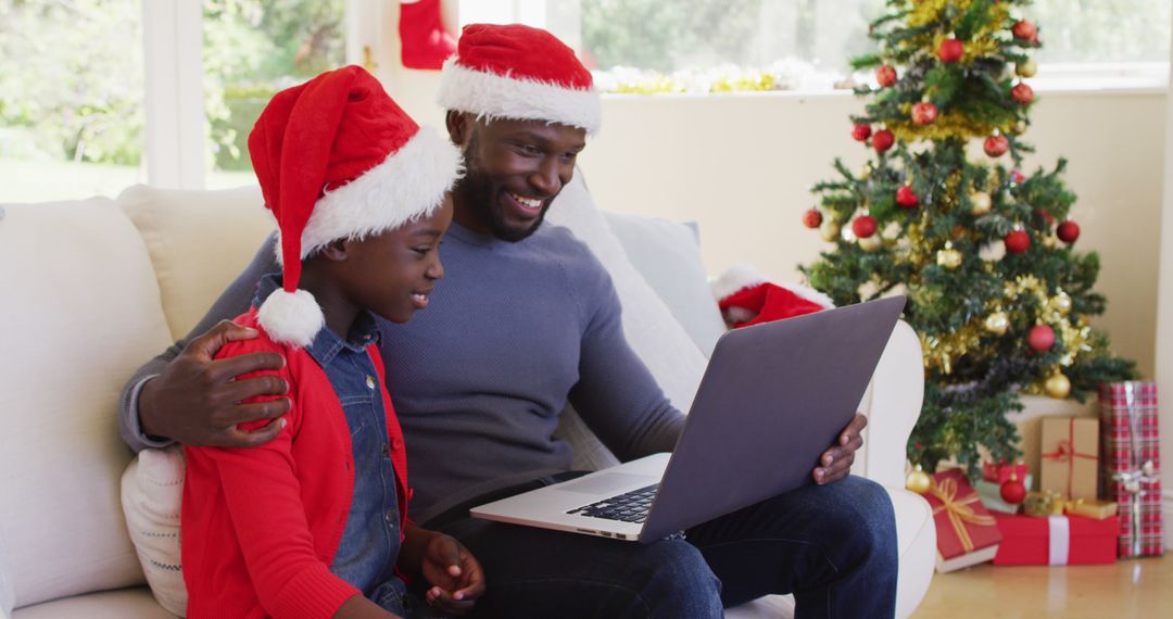 Father and Child Celebrating Christmas with Video Call on Laptop - Free Images, Stock Photos and Pictures on Pikwizard.com