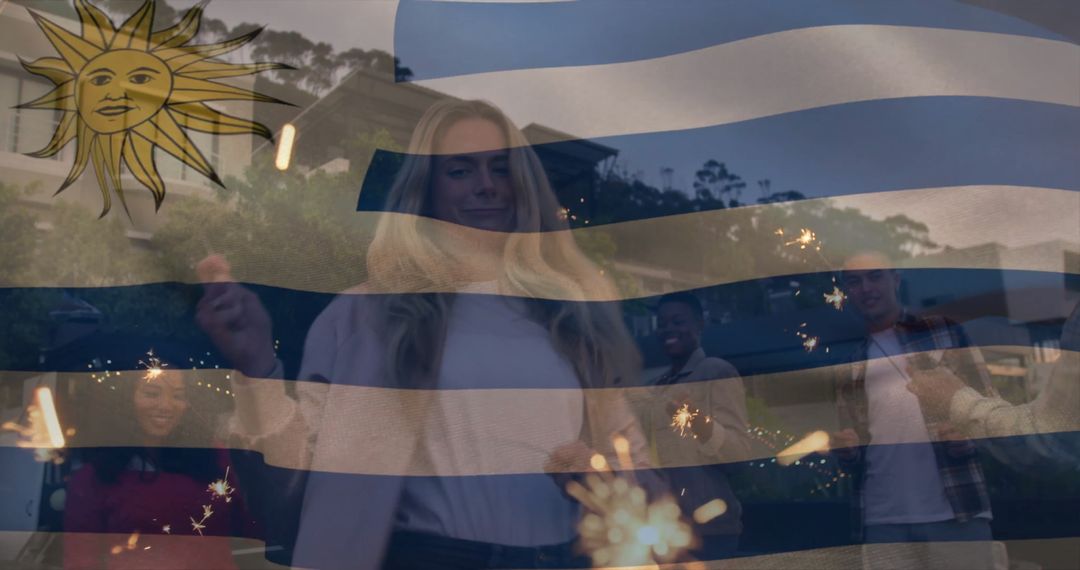 Multicultural Group Holding Sparklers Celebrating Under Uruguayan Flag