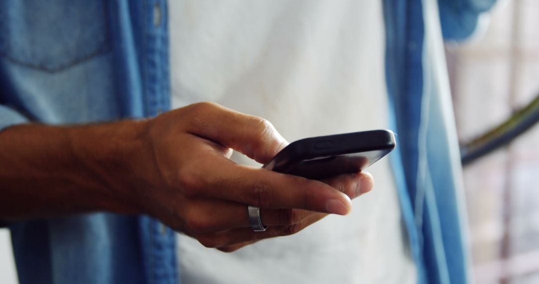 Mechanic Using Smartphone for Checking Jobs in Workshop