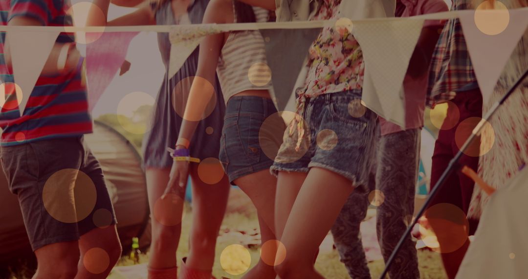 Friends Dancing at Lively Beach Party with Glowing Lights
