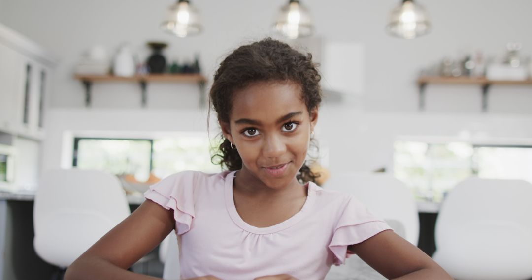 Smiling African American Girl Portrait in Modern Kitchen - Free Images, Stock Photos and Pictures on Pikwizard.com