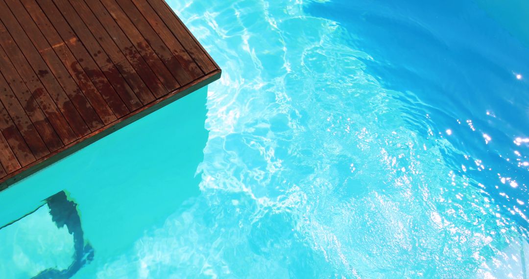 Inviting Blue Swimming Pool with Wooden Deck - Free Images, Stock Photos and Pictures on Pikwizard.com