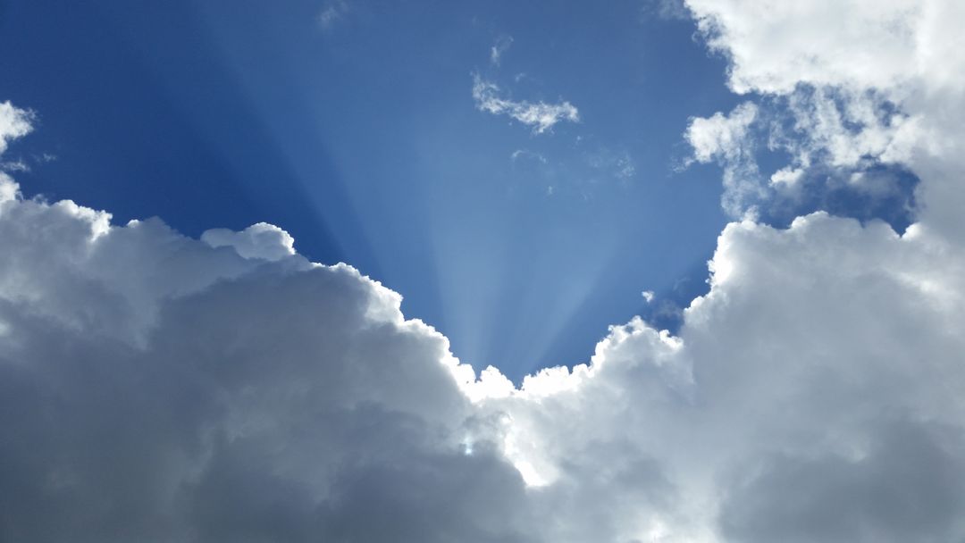 Beautiful Cloudscape with Sun Rays in Blue Sky - Free Images, Stock Photos and Pictures on Pikwizard.com