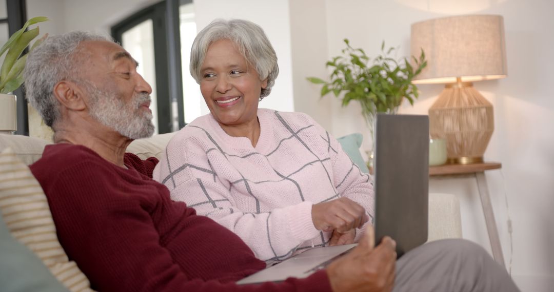 Happy Elderly Couple Enjoying Technology at Home