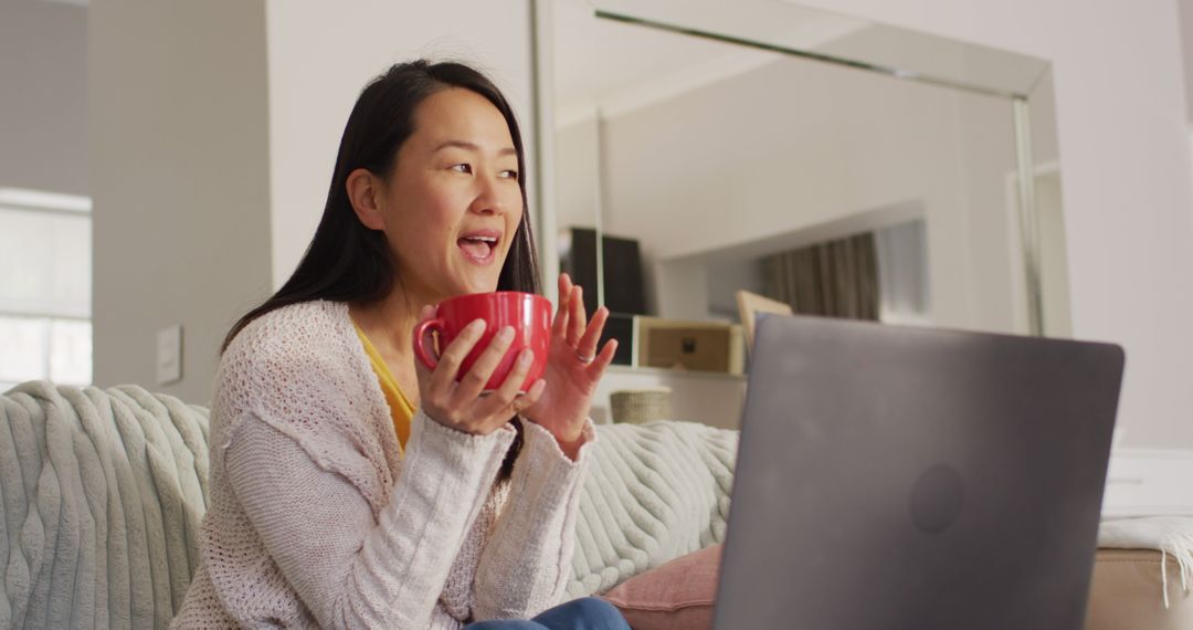 Image of happy asian woman wit coffee using laptop - Free Images, Stock Photos and Pictures on Pikwizard.com