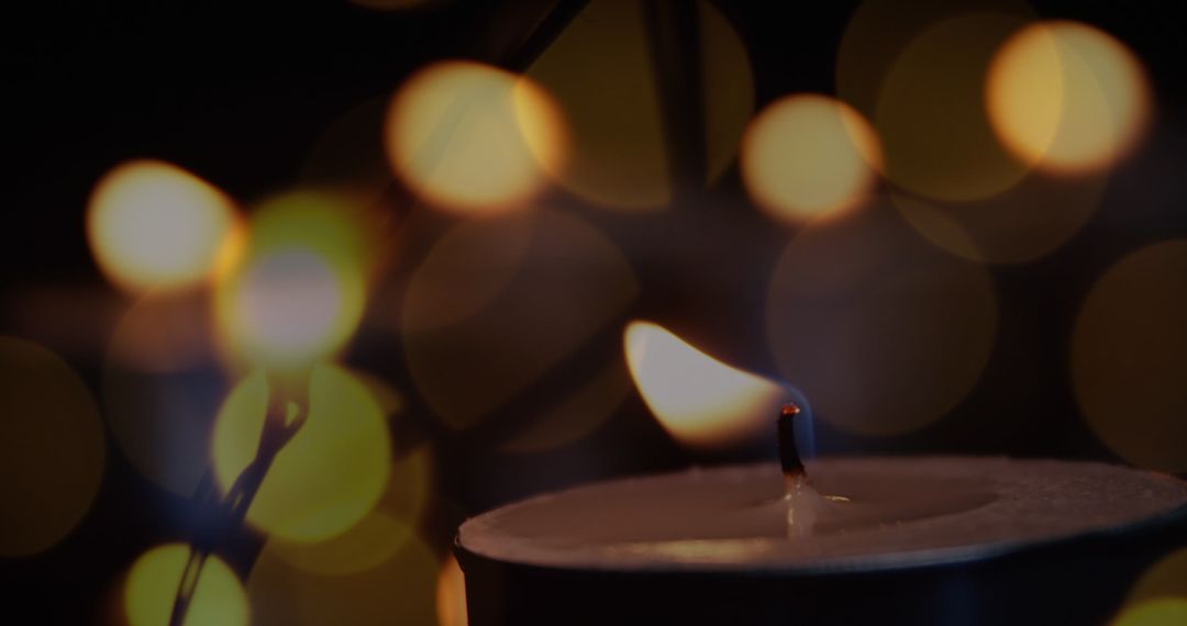 Lit Candle with Soft Glow of Fairy Lights