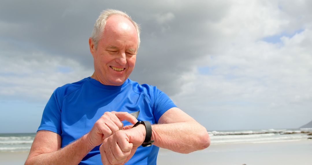 Senior Man Tracking Fitness on Smartwatch During Beach Run - Free Images, Stock Photos and Pictures on Pikwizard.com