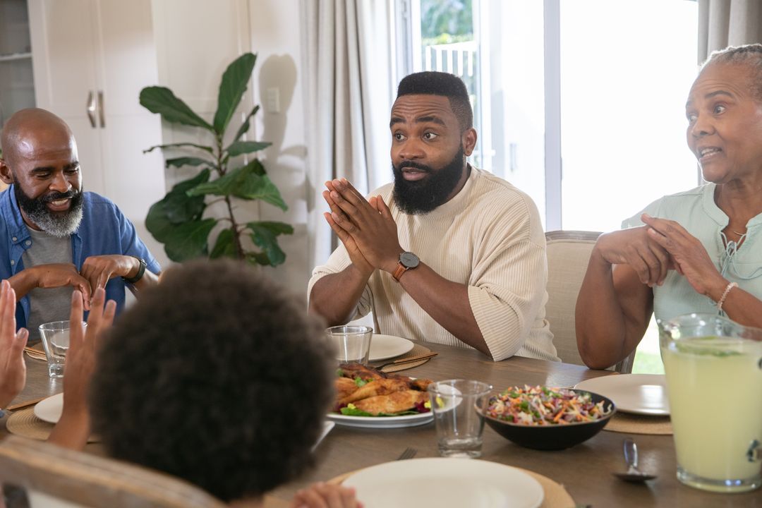 Diverse Family Expressing Unity and Gratitude Before Meal