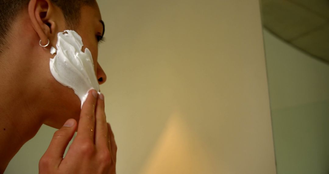 Person Applying Shaving Foam to Face in Bathroom - Free Images, Stock Photos and Pictures on Pikwizard.com